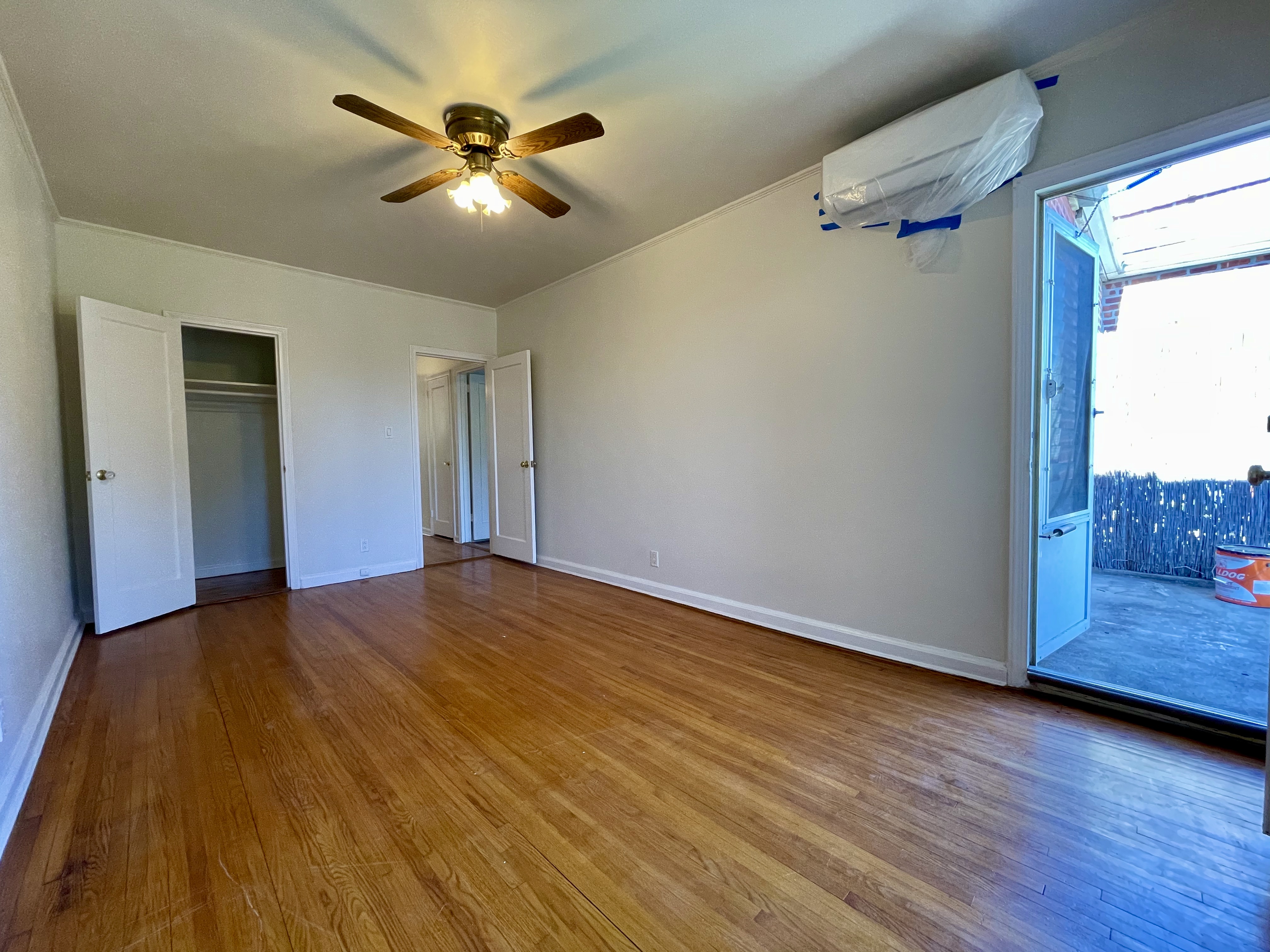 144 96th Street Brooklyn, NY 11209 - Photo 6 of 9 a view of a livingroom with a ceiling fan and wooden floor