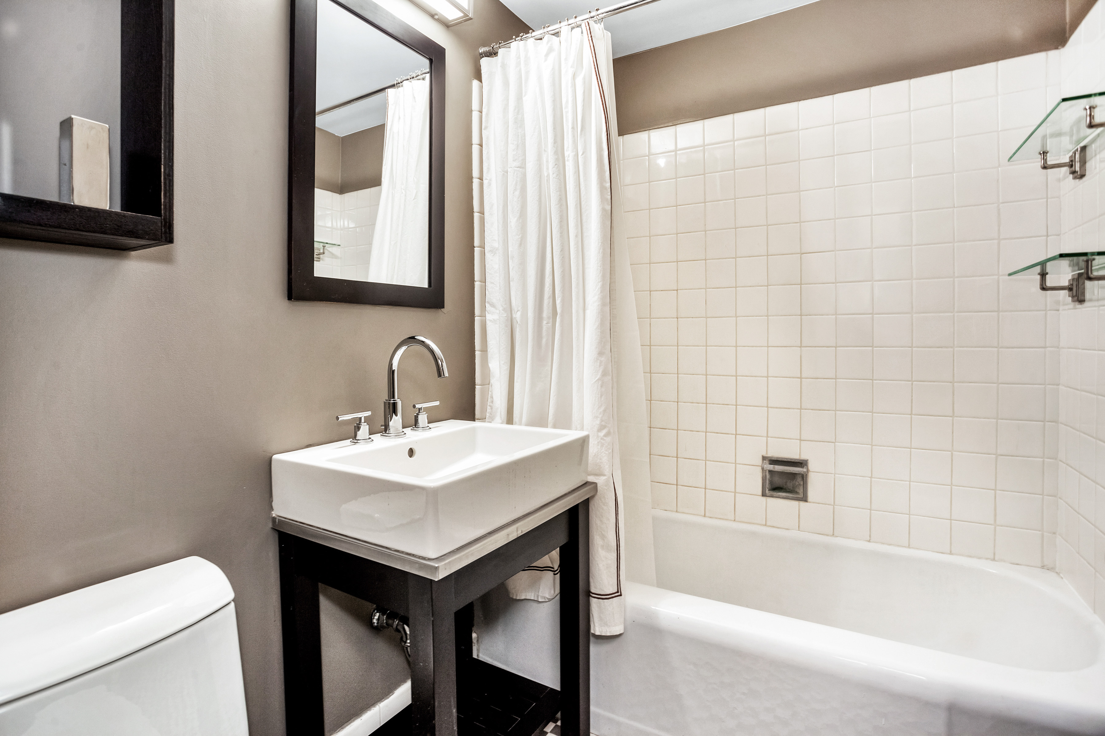 80 Park Avenue, Unit 17B Manhattan, NY 10016 - Photo 7 of 10 a bathroom with a sink toilet and bathtub