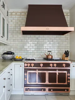 a kitchen with stove and cabinets