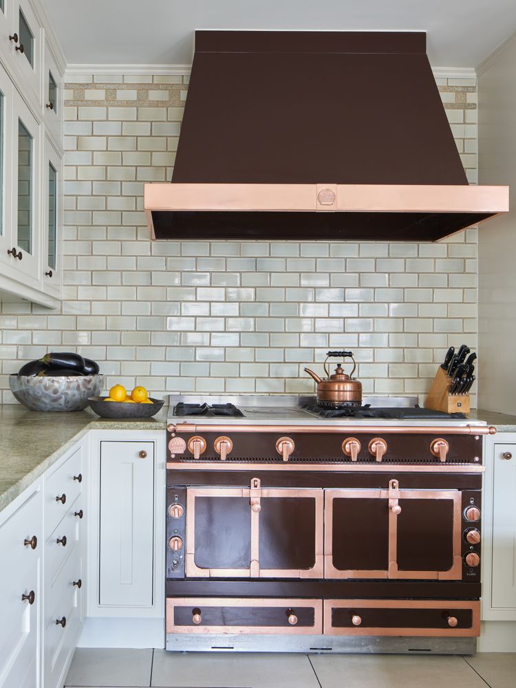 a kitchen with stove and cabinets