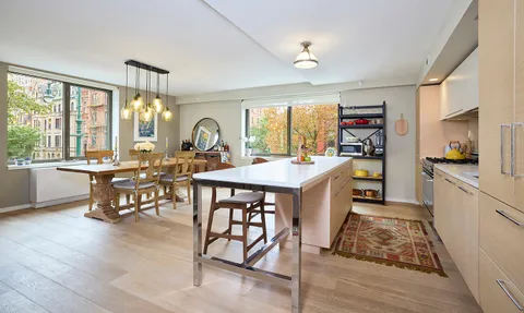 a large kitchen with a table and chairs