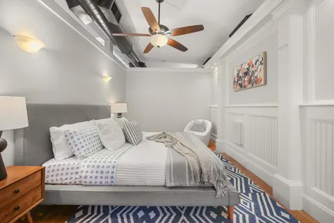 a bedroom with bed and a window