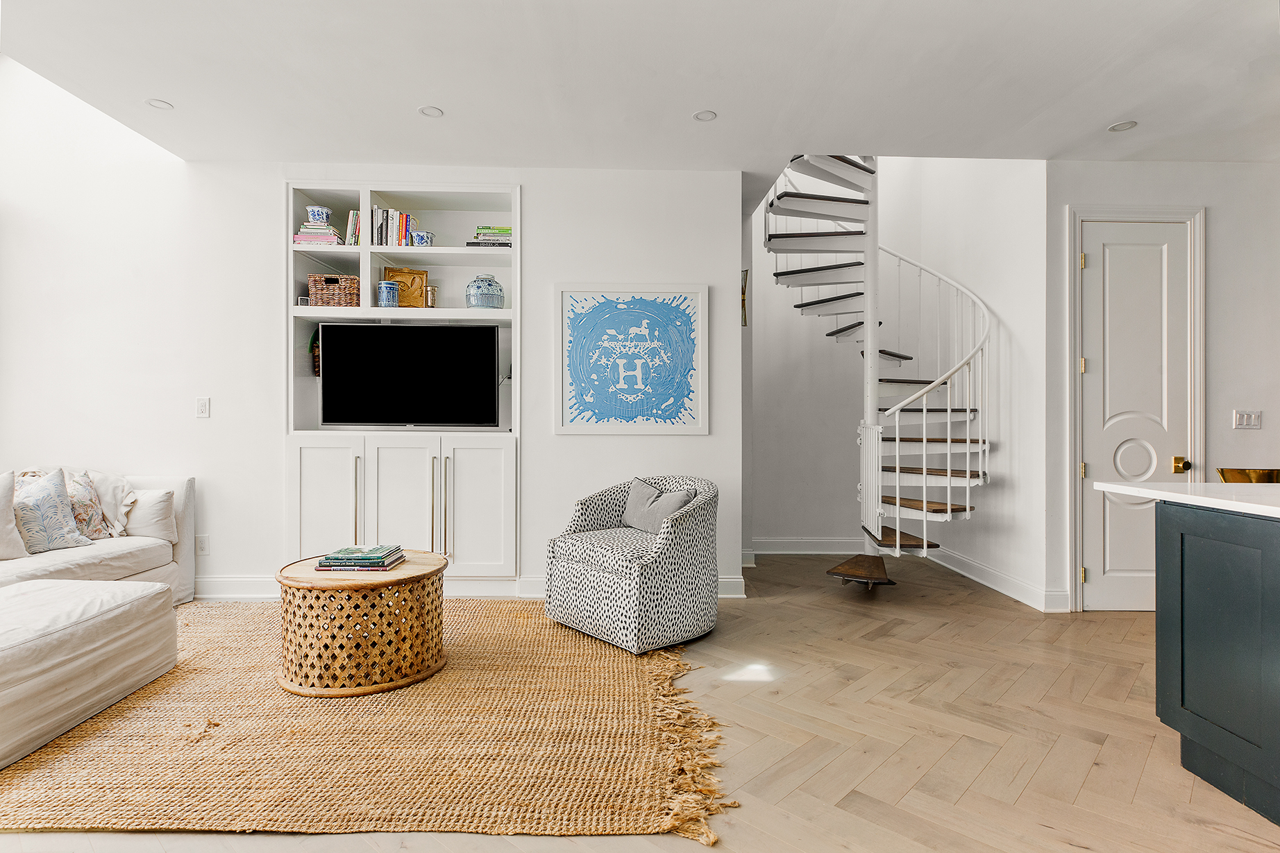 529 West 42nd Street, Unit 9R Manhattan, NY 10036 - Photo 2 of 10 a living room with furniture and a flat screen tv