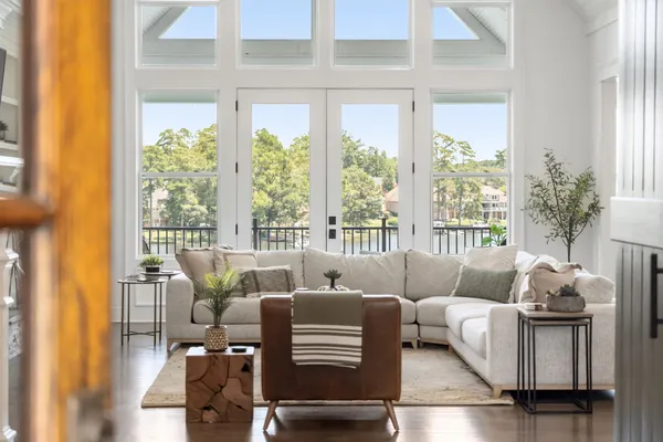 a living room with furniture and floor to ceiling windows