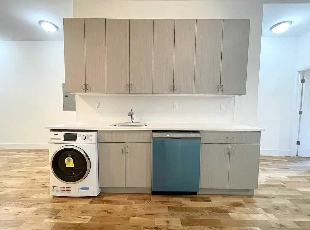 1128 Bushwick Avenue, Unit A Brooklyn, NY 11221 - Photo 2 of 14 a kitchen with a sink a washer and dryer