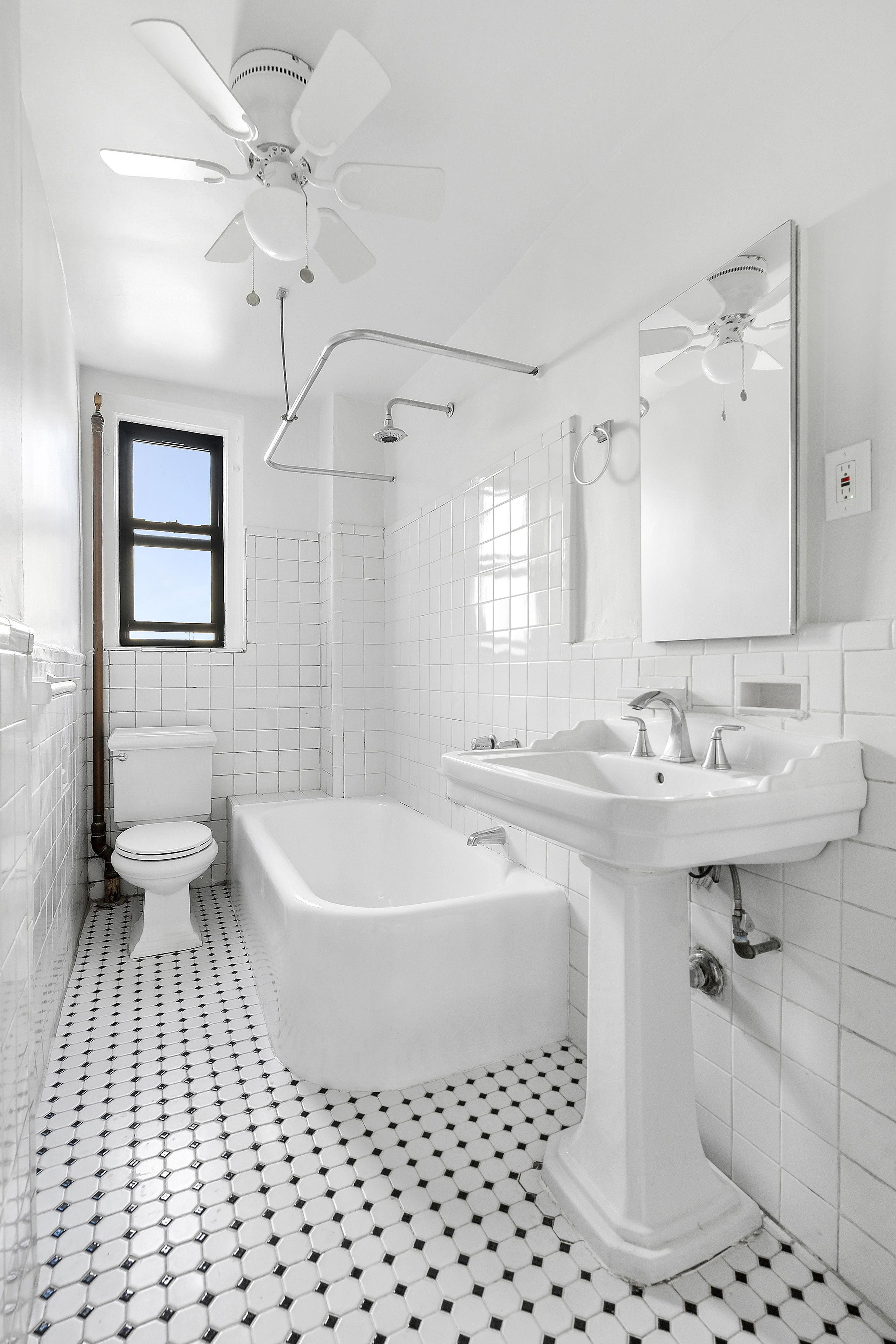 321 East 54th Street, Unit 10B Manhattan, NY 10022 - Photo 8 of 13 a bathroom with a sink a toilet a mirror and shower