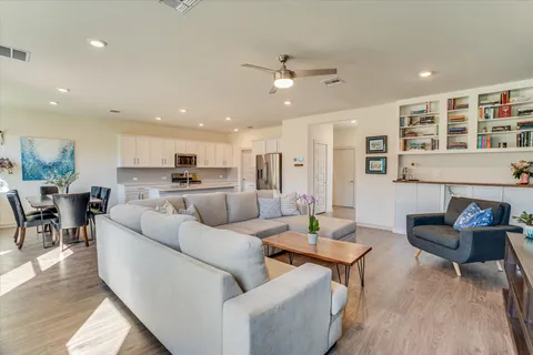 a living room kitchen with furniture and kitchen view