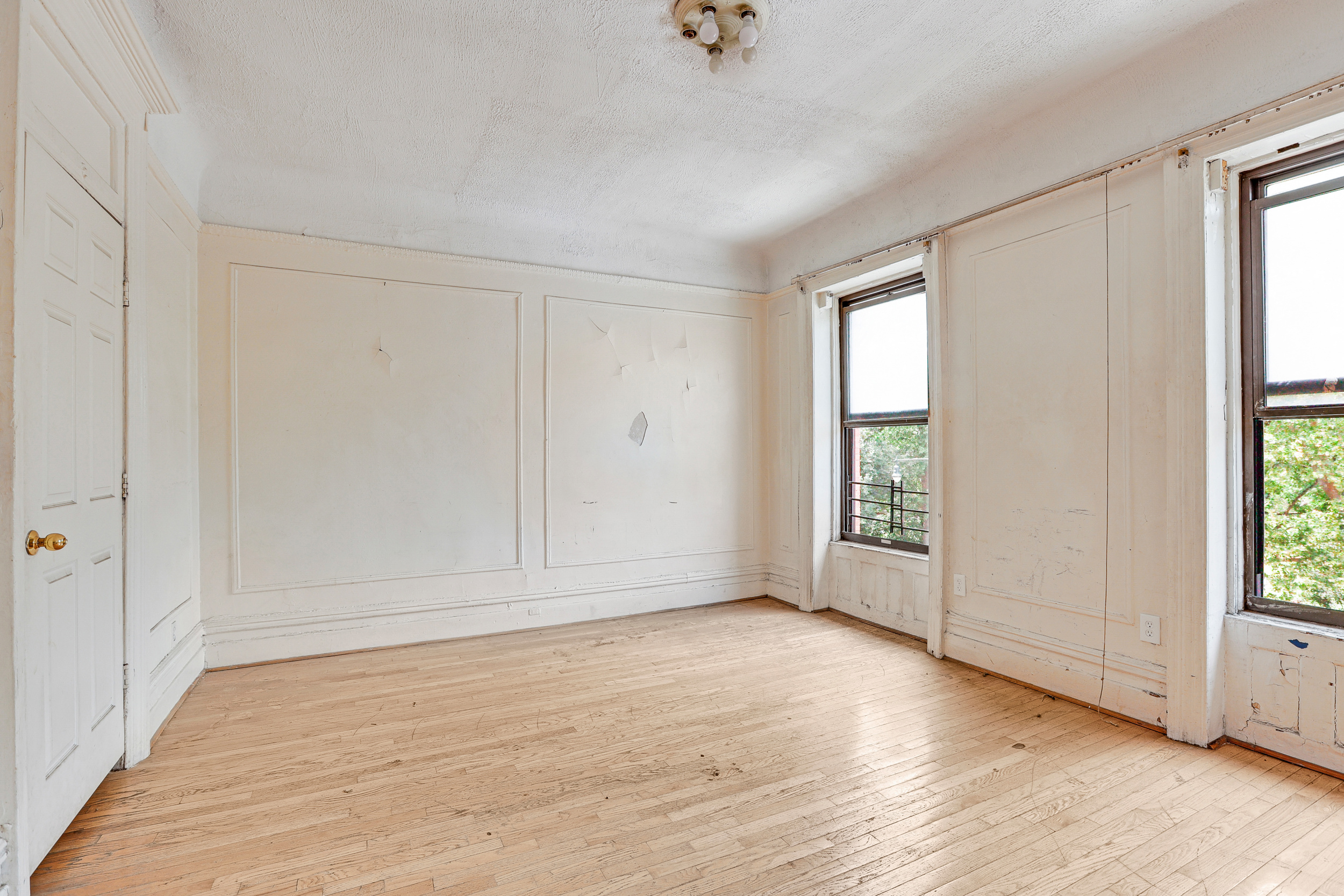 282 Manhattan Avenue, Unit 3N Manhattan, NY 10026 - Photo 6 of 17 an empty room with wooden floor and windows