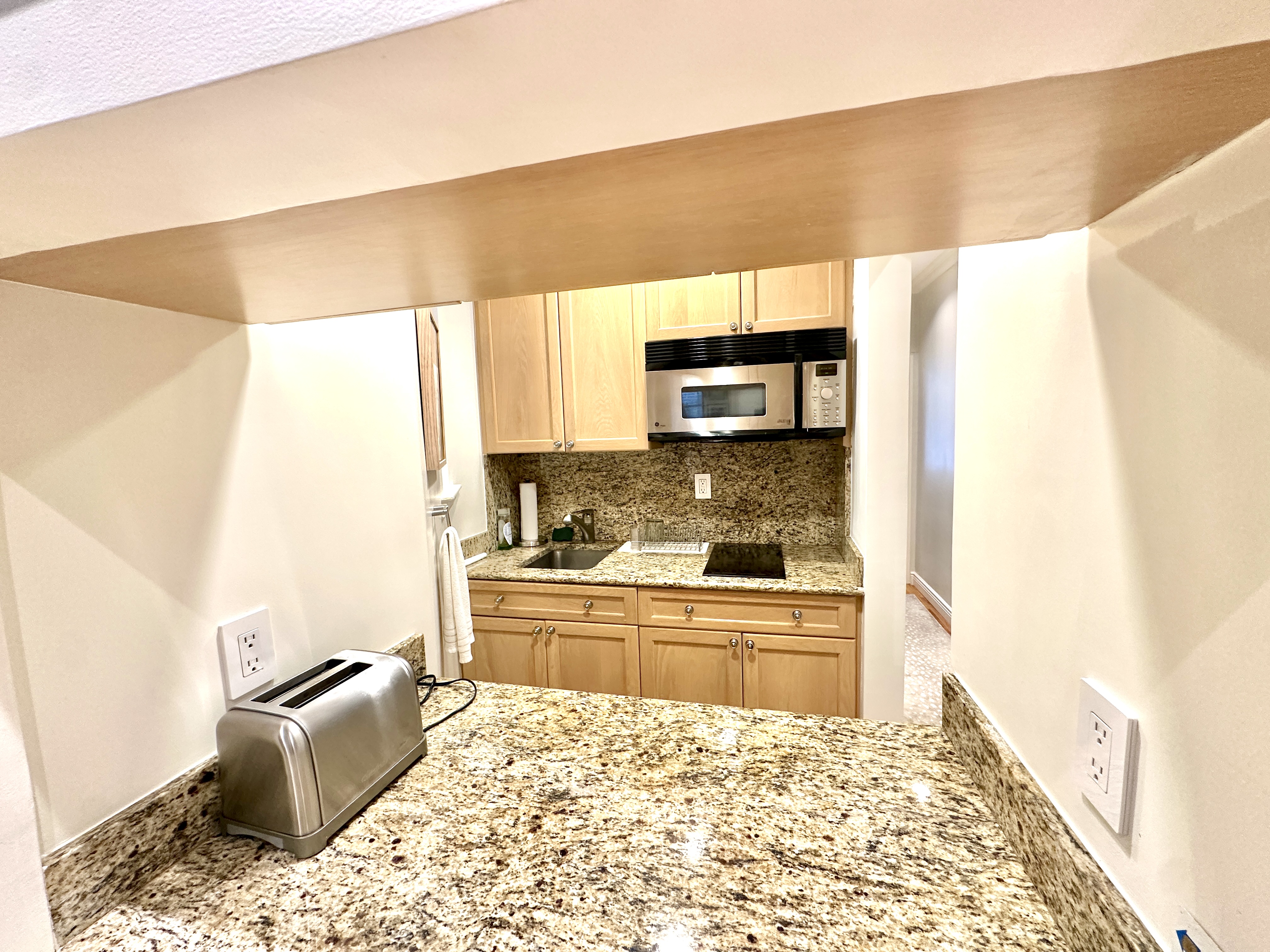 20 East 88th Street, Unit 5B Manhattan, NY 10128 - Photo 2 of 8 a kitchen with a stove a sink and a refrigerator