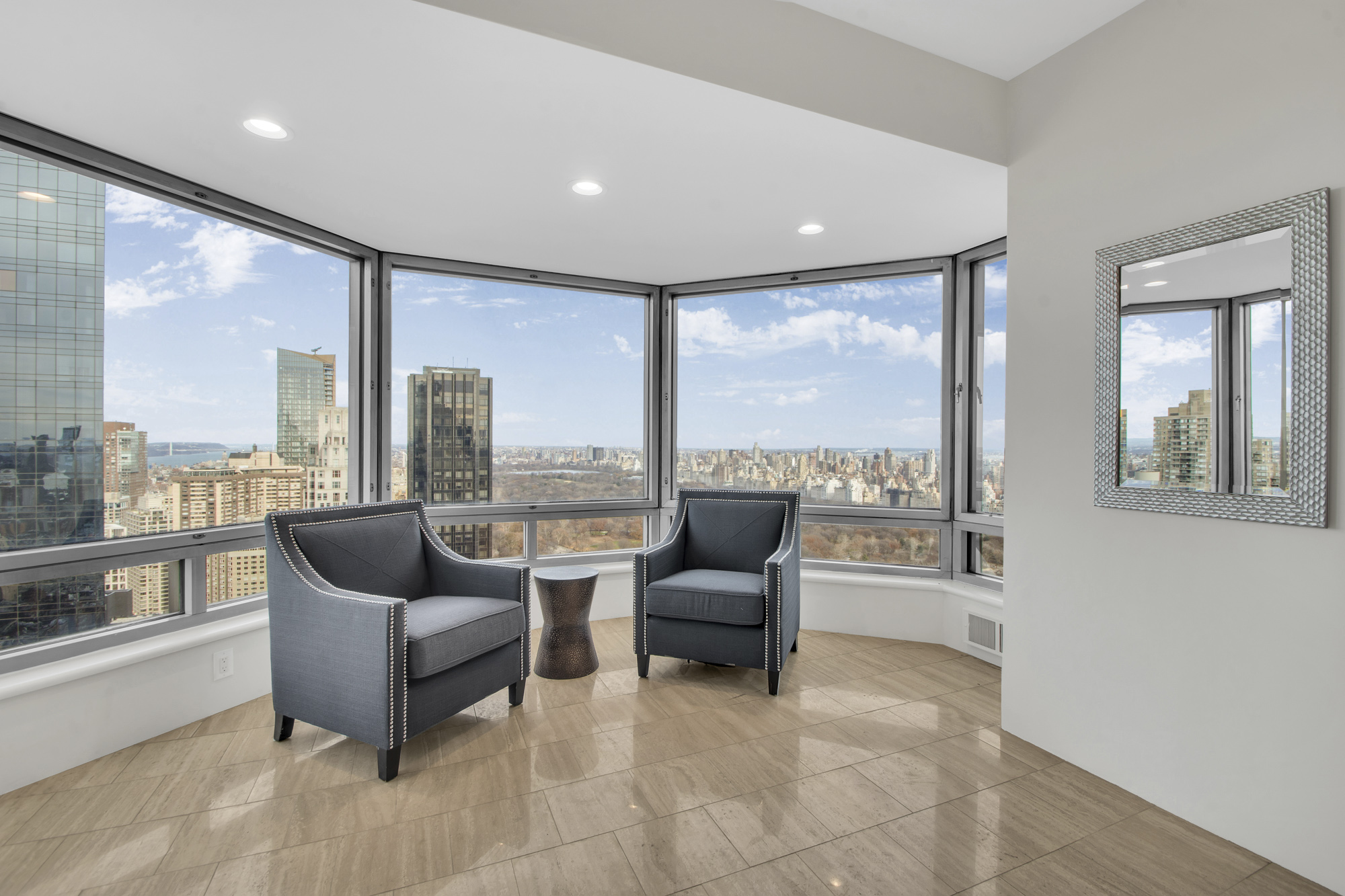 301 West 57th Street, Unit 48A Manhattan, NY 10019 - Photo 5 of 22 a living room with furniture and a floor to ceiling window