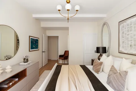 a bedroom with bed and a chandelier