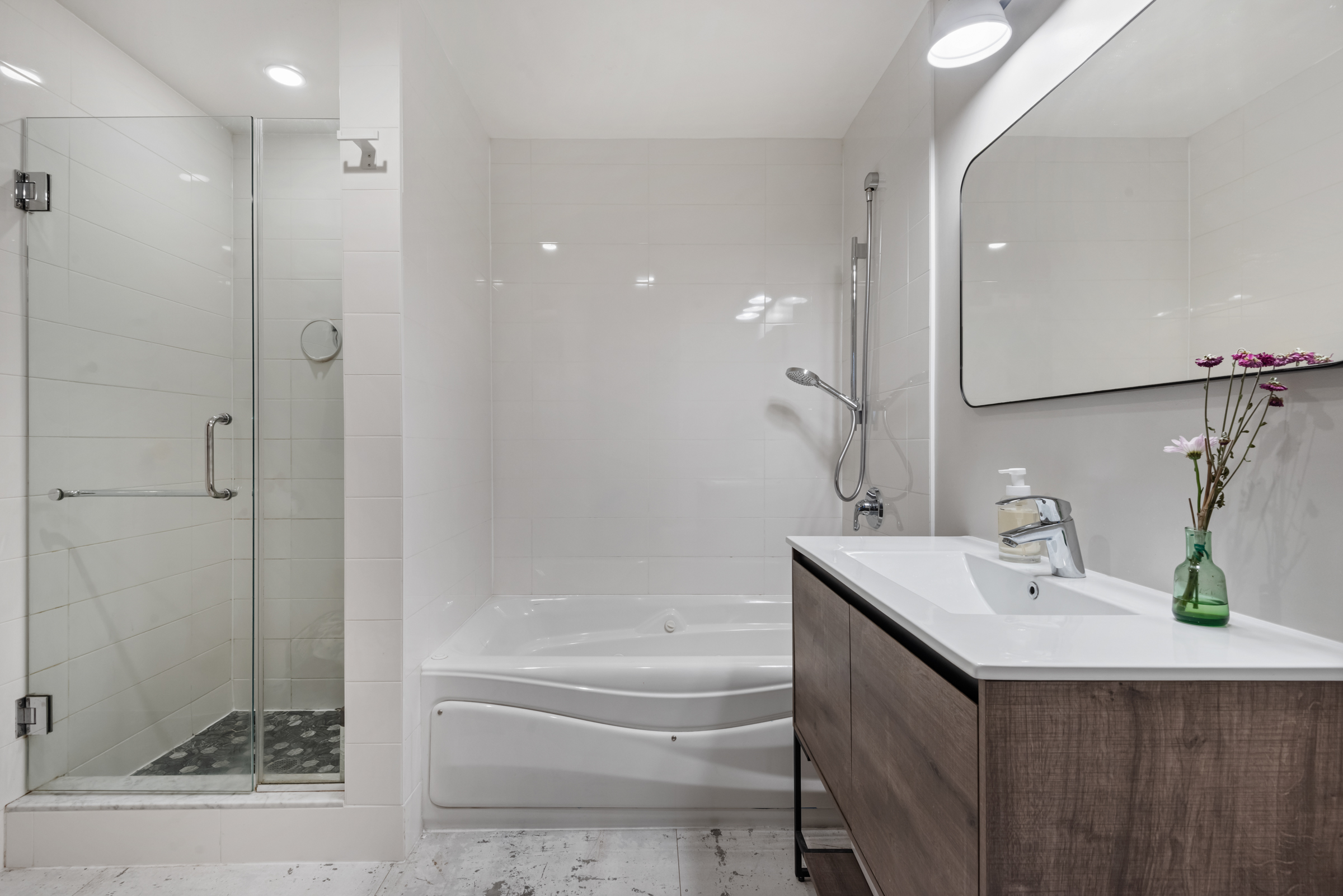 105 Lexington Avenue, Unit 2G Brooklyn, NY 11238 - Photo 11 of 17 a bathroom with a bathtub sink vanity and mirror