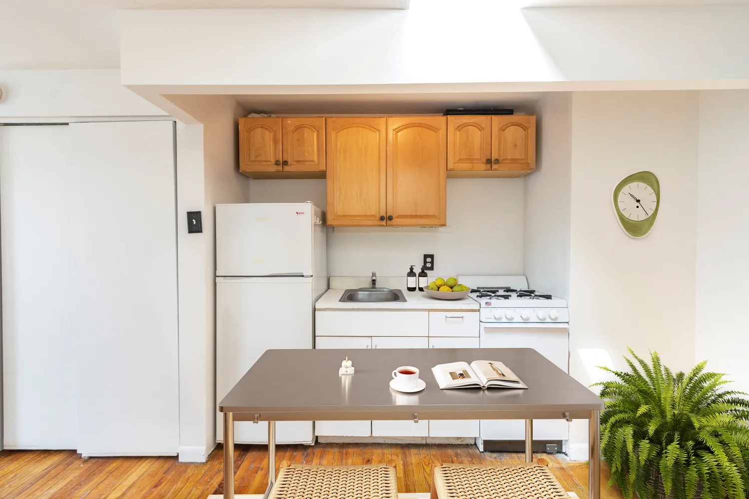 a kitchen with a refrigerator and a stove top oven