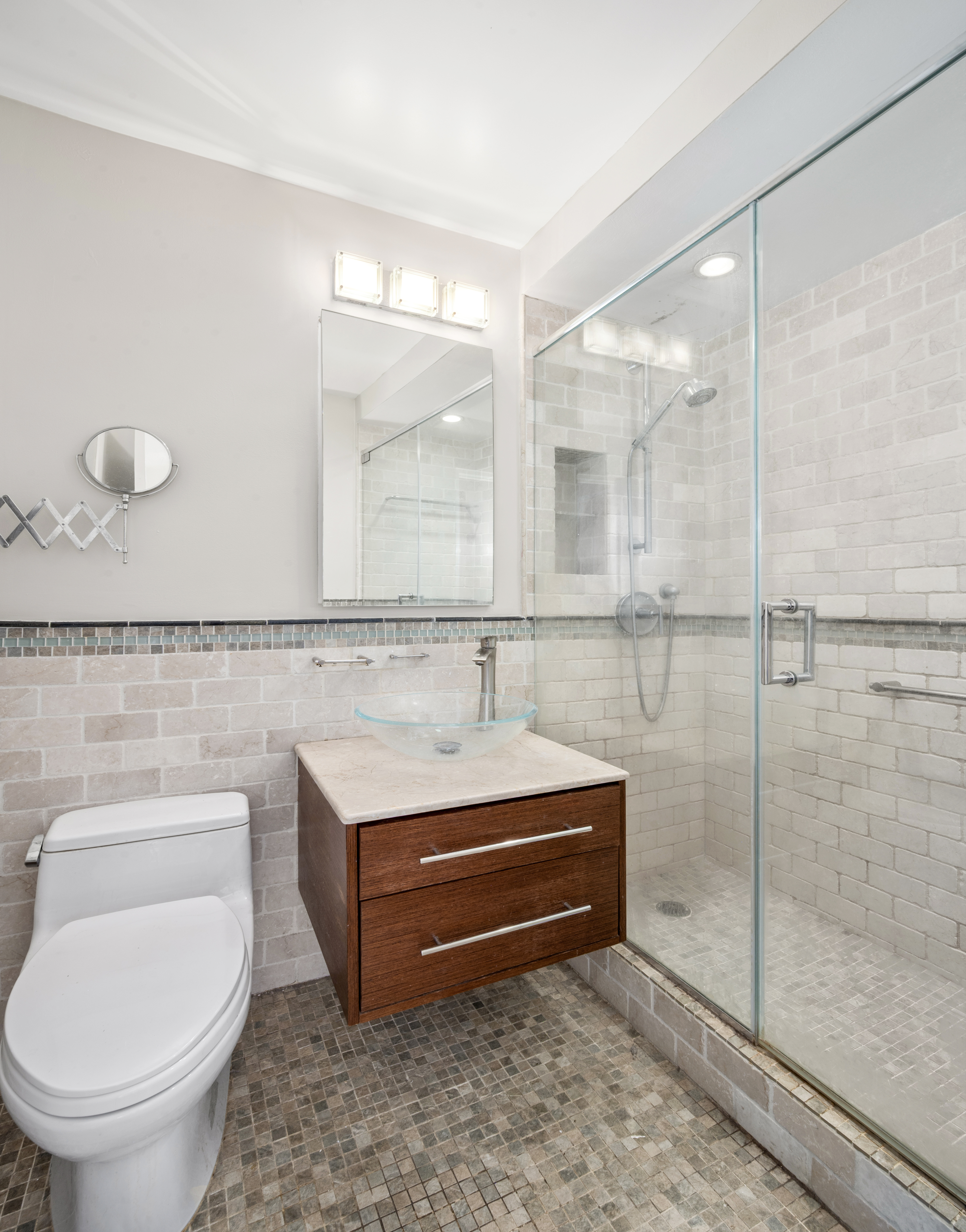 77 7th Avenue, Unit 10N Manhattan, NY 10011 - Photo 10 of 13 a bathroom with a sink a toilet and a shower