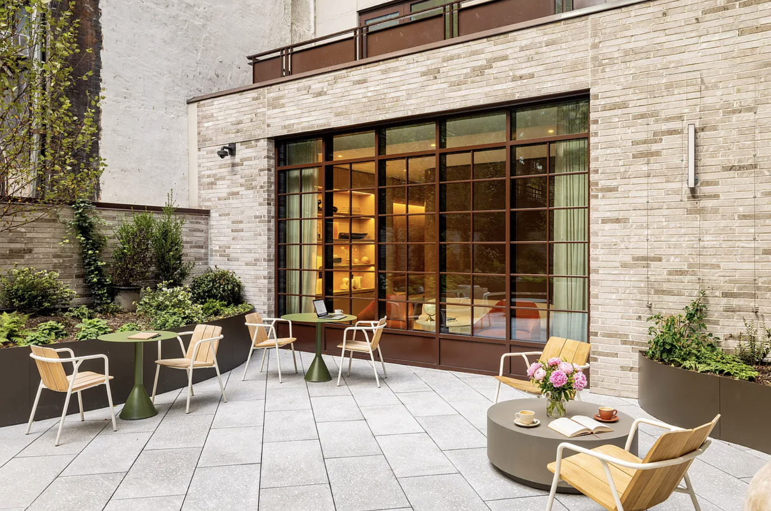 300 East 50th Street, Unit 18A Manhattan, NY 10022 - Photo 20 of 27 a view of a patio with table and chairs and potted plants