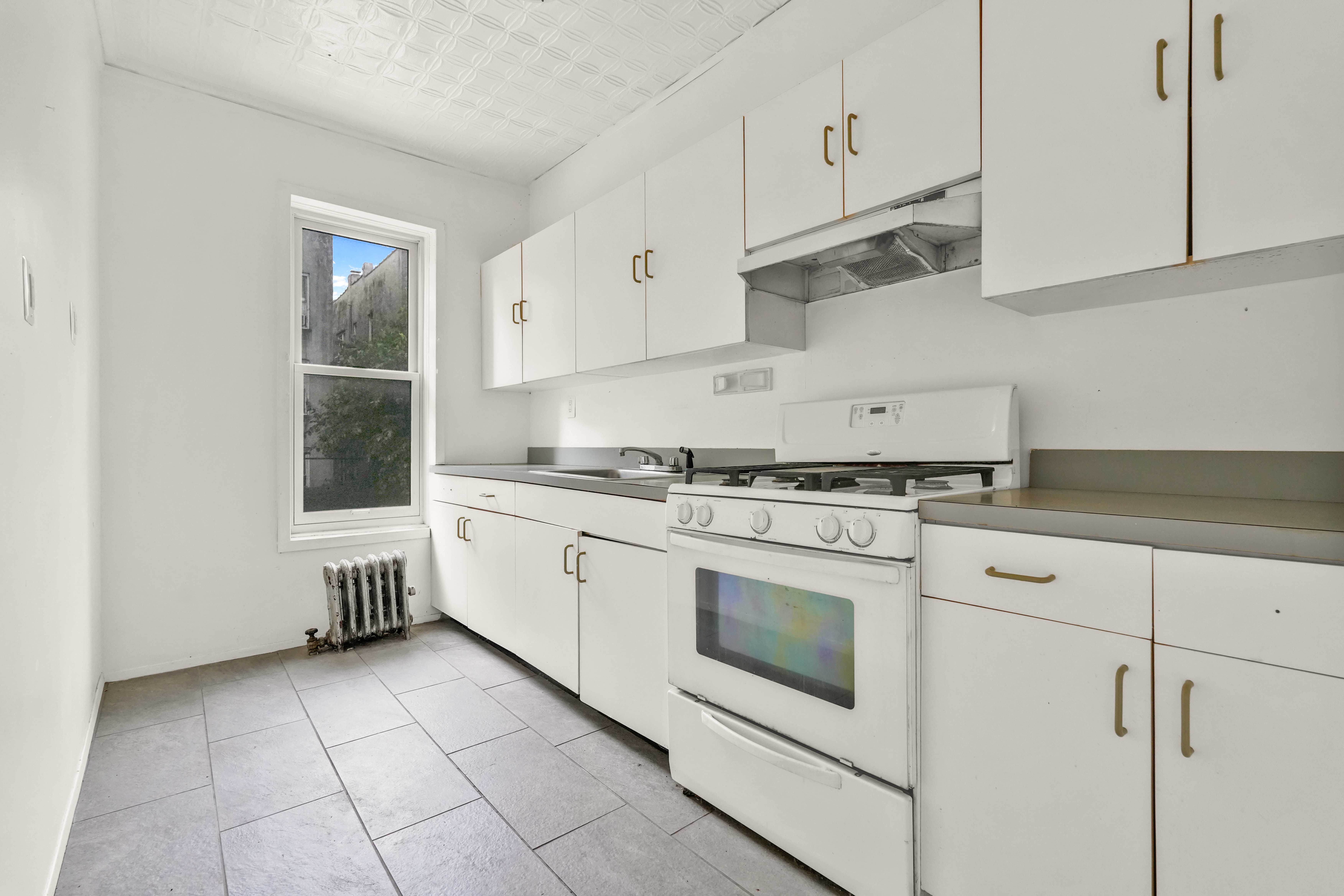 278 Lefferts Avenue Brooklyn, NY 11225 - Photo 13 of 56 a kitchen with cabinets appliances and a window