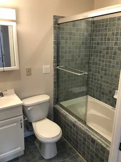 a bathroom with a toilet a sink and bathtub