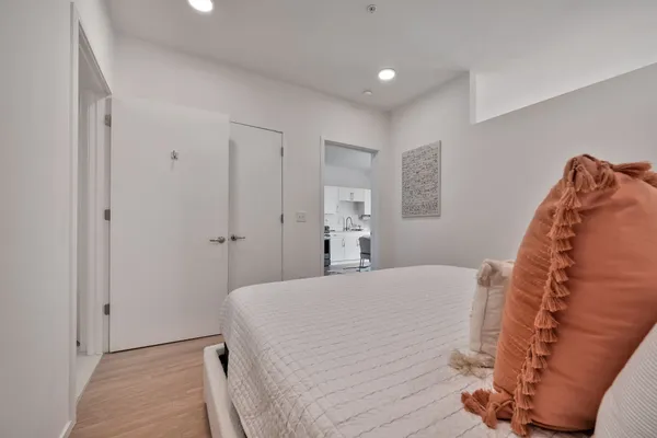 a bedroom with a bed and a mirror