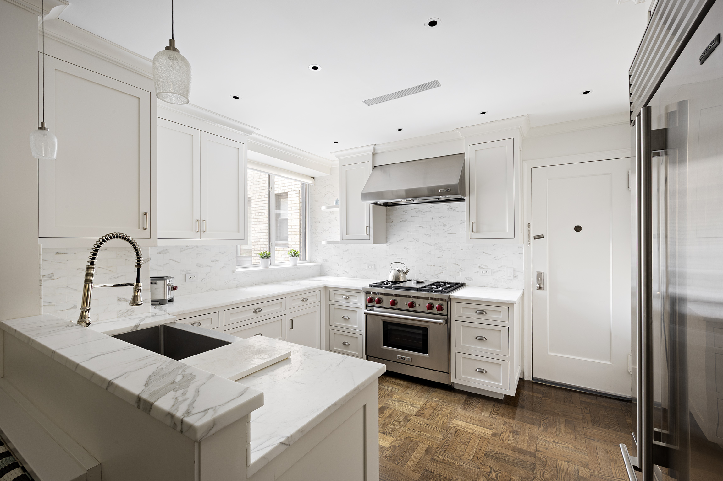 21 East 87th Street, Unit 10D Manhattan, NY 10128 - Photo 2 of 11 a kitchen with stainless steel appliances granite countertop a sink stove and refrigerator