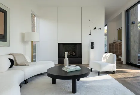 a living room with furniture a lamp and a fireplace