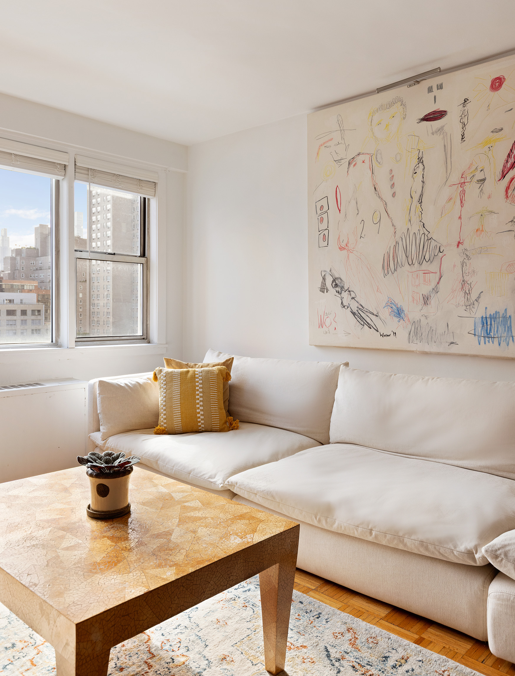 525 East 82nd Street, Unit 12E Manhattan, NY 10028 - Photo 4 of 29 a living room with furniture and window
