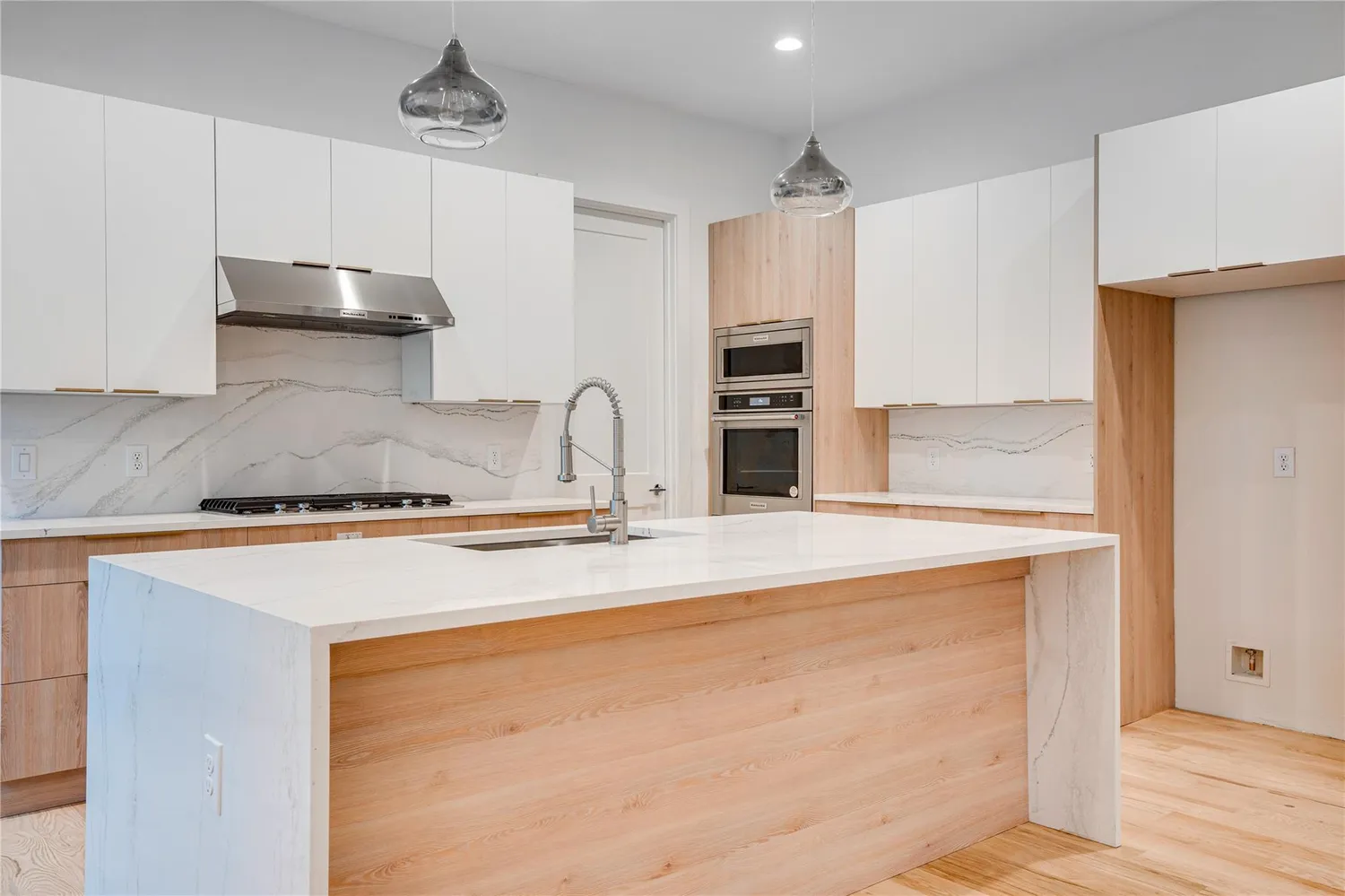 a kitchen with stainless steel appliances granite countertop a sink a stove and a refrigerator