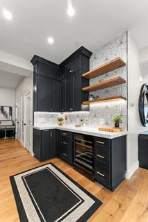 a kitchen with stainless steel appliances a sink and cabinets