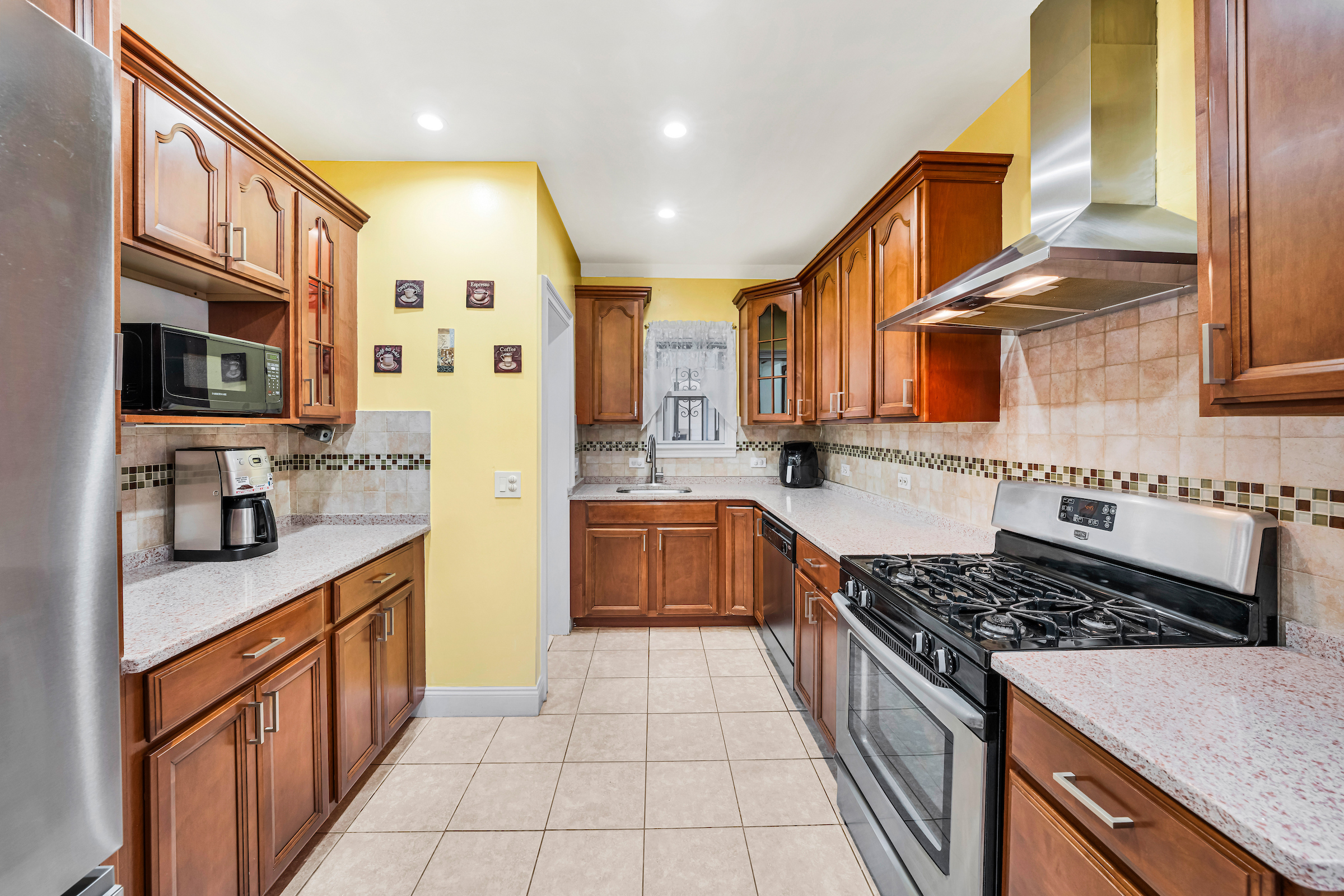 132-11 107th Avenue Queens, NY 11419 - Photo 4 of 14 a kitchen with stainless steel appliances granite countertop a stove and a sink