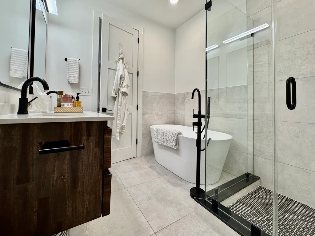 a bathroom with a sink a toilet and shower