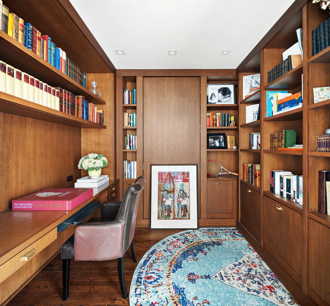 a bedroom with furniture and a book shelf
