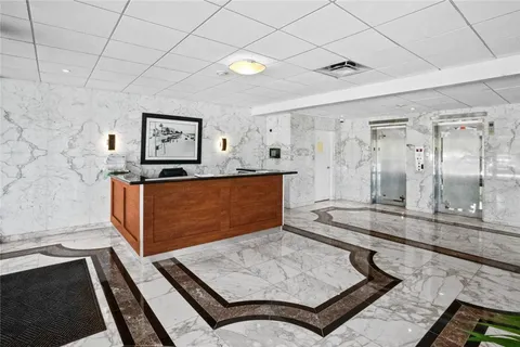 a large white kitchen with a large window