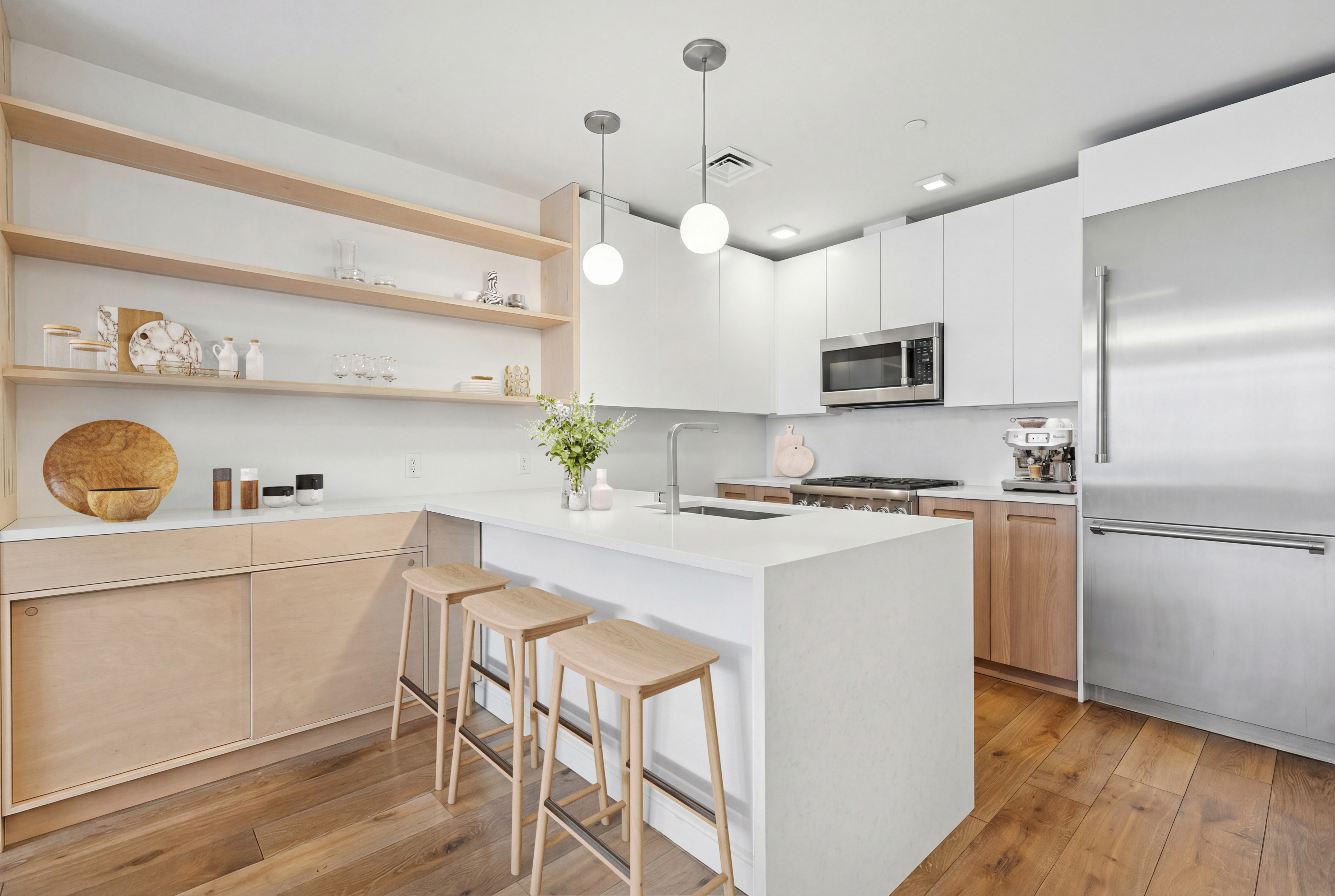 147 Hope Street, Unit 4A Brooklyn, NY 11211 - Photo 4 of 12 a kitchen with kitchen island white cabinets and stainless steel appliances