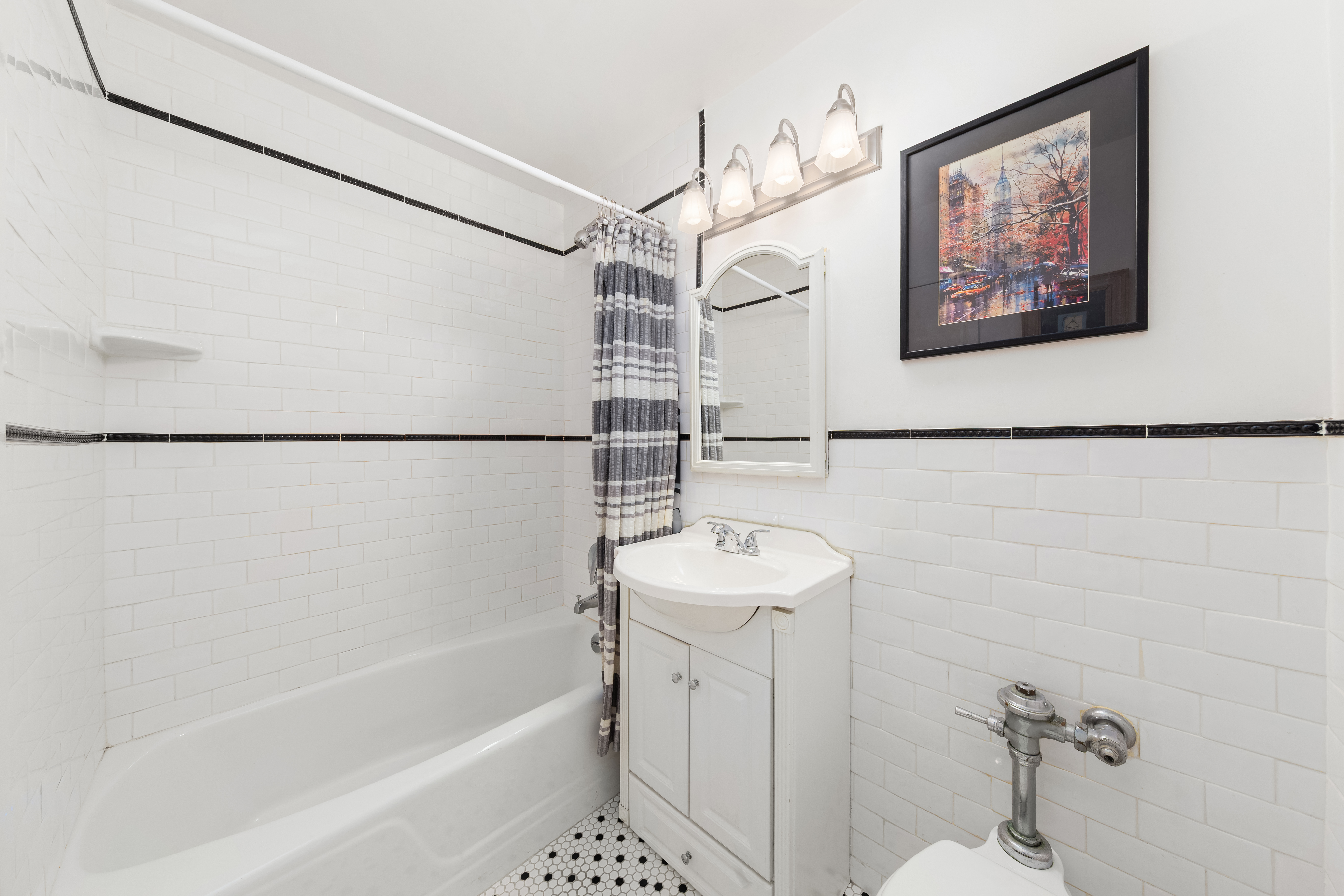 1160 3rd Avenue, Unit 3B Manhattan, NY 10065 - Photo 4 of 6 a bathroom with a sink a bathtub and a shower