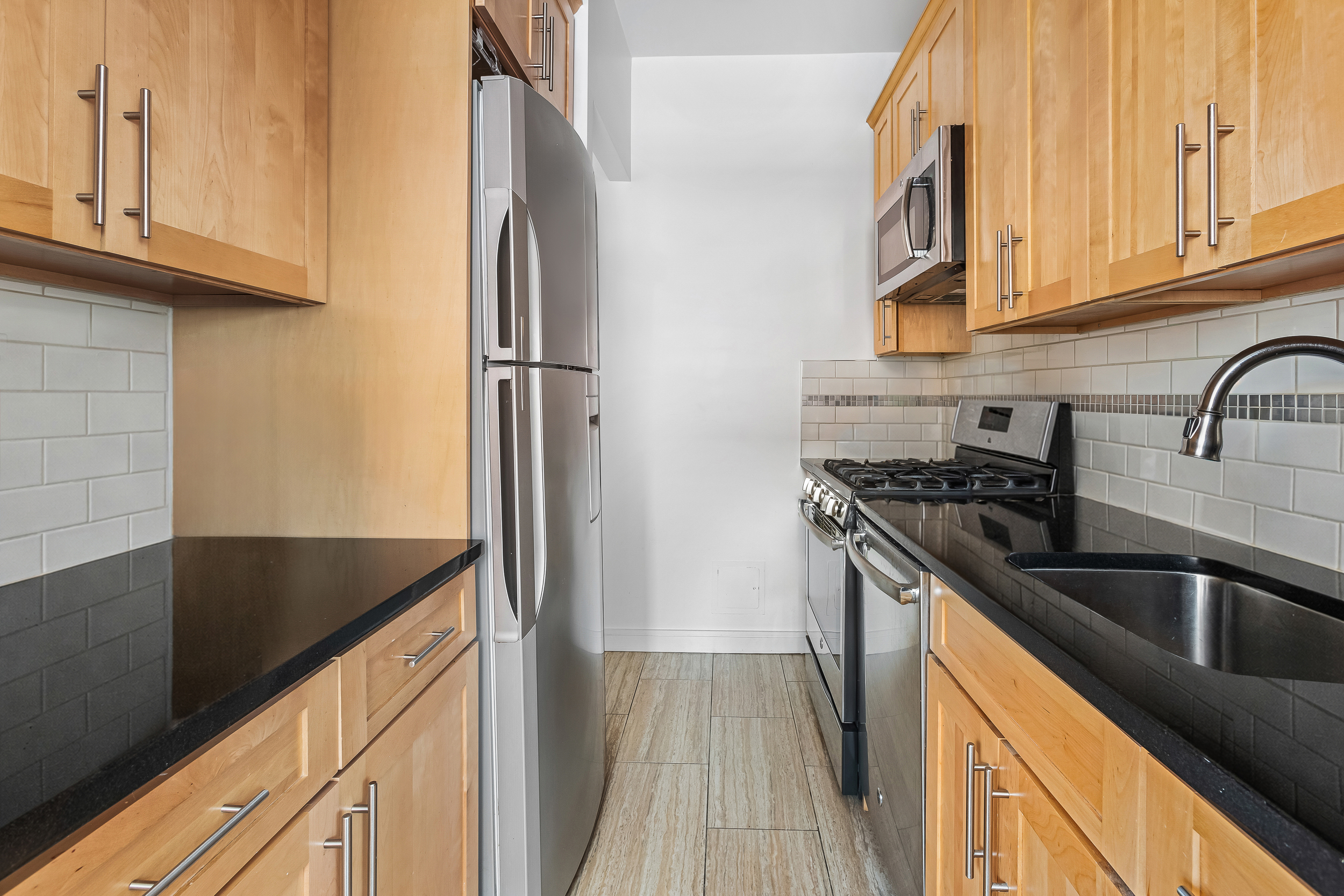 185 Smith Street Brooklyn, NY 11201 - Photo 12 of 14 a kitchen with stainless steel appliances granite countertop a refrigerator and a sink