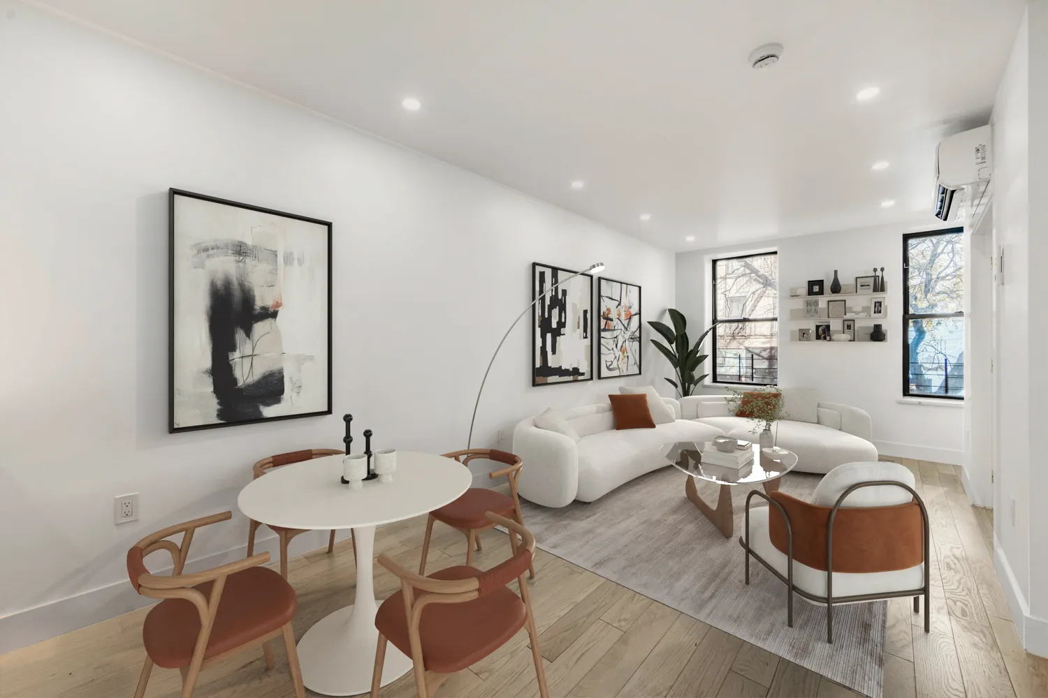 a living room with furniture and wooden floor