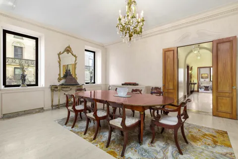 a view of a dining room with furniture and a chandelier