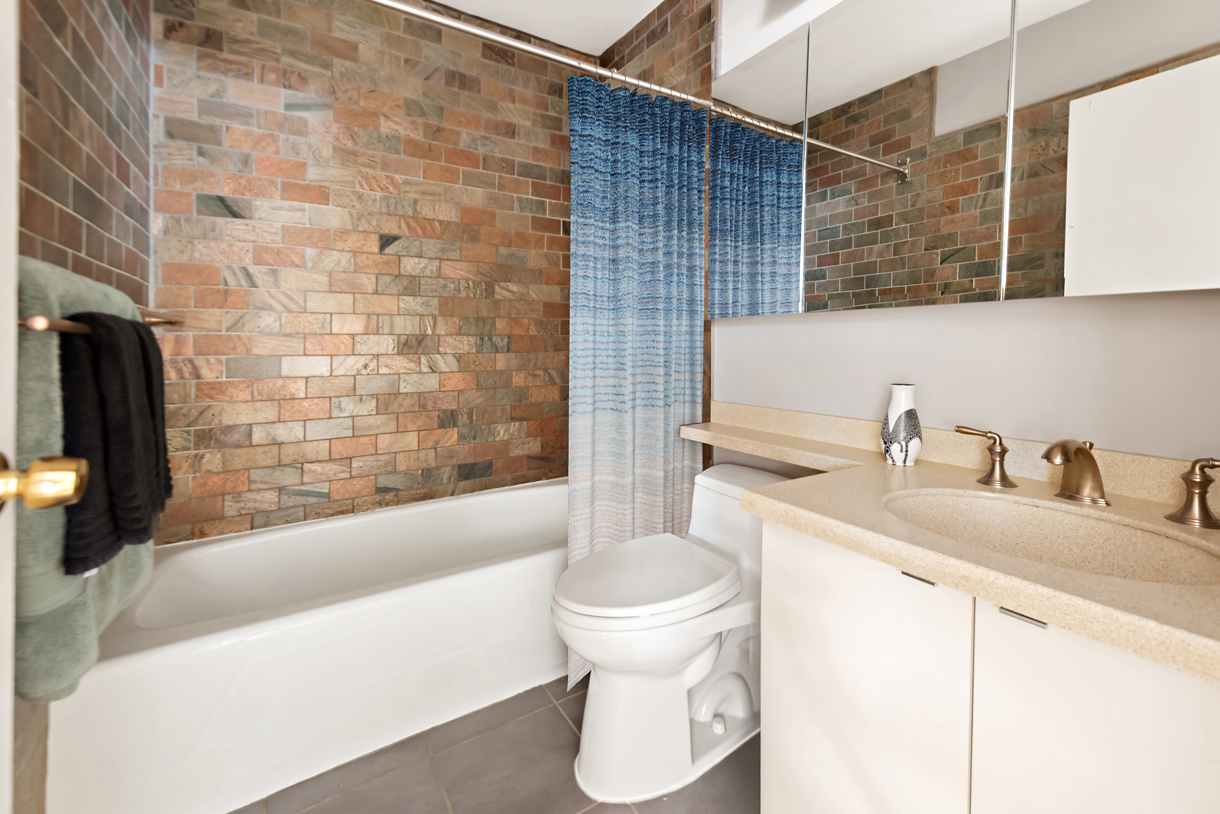 137 East 36th Street, Unit 12G Manhattan, NY 10016 - Photo 7 of 15 a bathroom with a sink toilet and shower