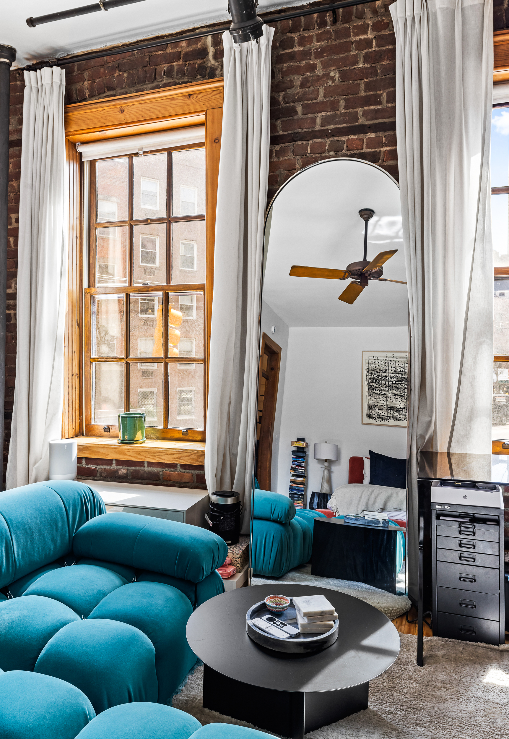 31 8th Avenue, Unit 1 Manhattan, NY 10014 - Photo 3 of 10 a living room with furniture and a large window