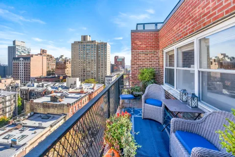 a balcony with wooden floor and furniture