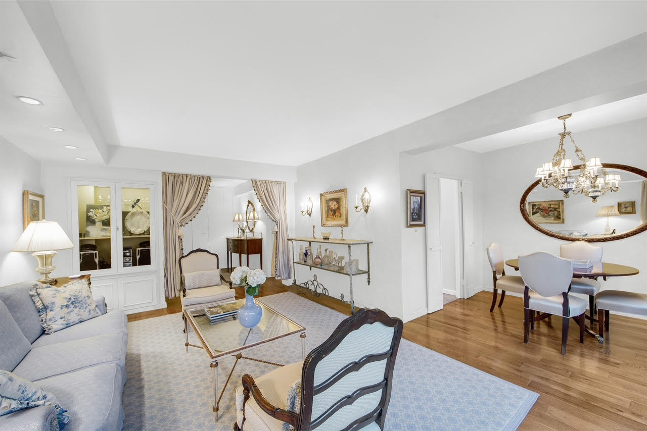 401 East 65th Street, Unit 16C Manhattan, NY 10065 - Photo 3 of 13 a living room with furniture a rug and a window