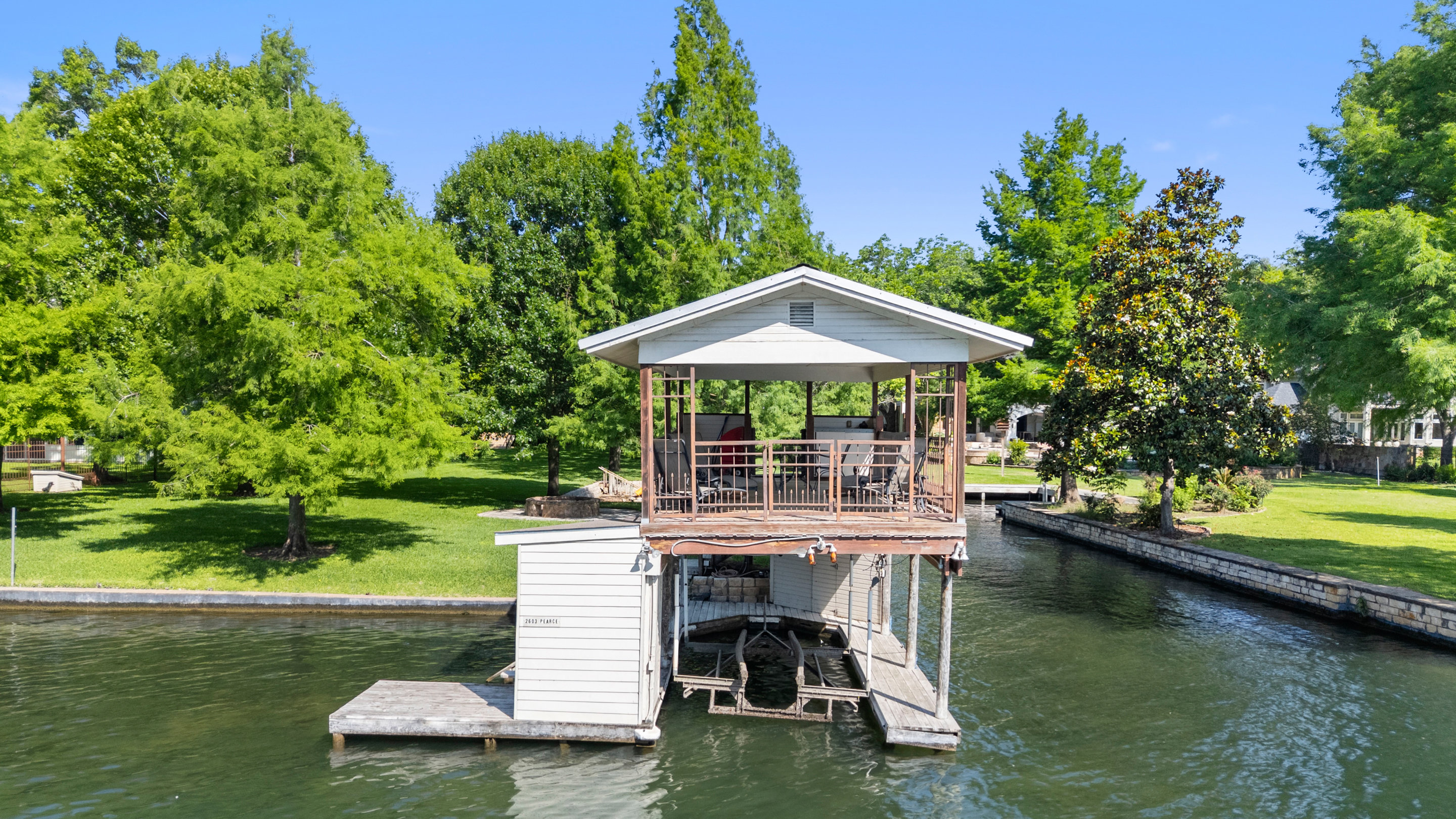 2603 Pearce Road Austin, TX 78730 - Photo 22 of 41 a view of a swimming pool with a table and chairs under an umbrella