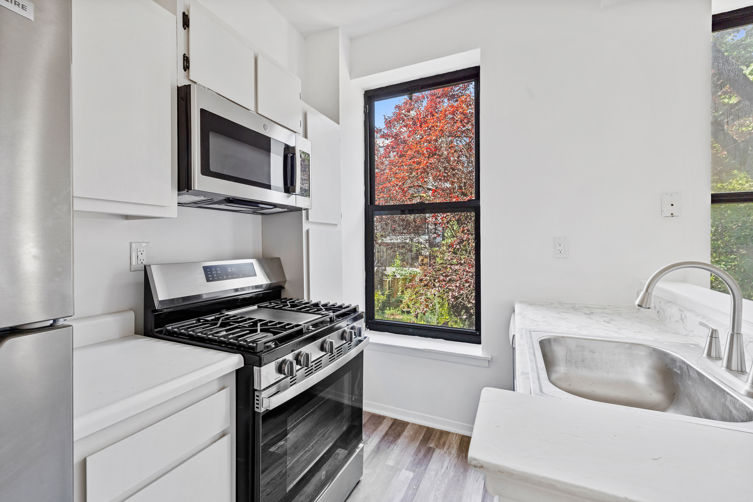 662 Warren Street Brooklyn, NY 11217 - Photo 3 of 9 a kitchen with microwave a sink and appliances