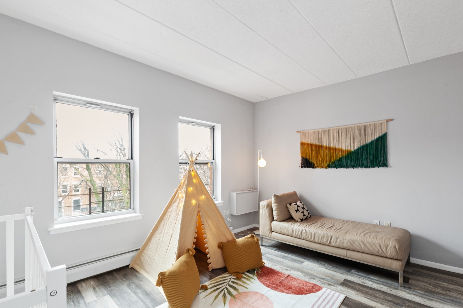 2551 Frederick Douglass Boulevard, Unit 2551D Manhattan, NY 10030 - Photo 6 of 11 a living room with furniture and a window