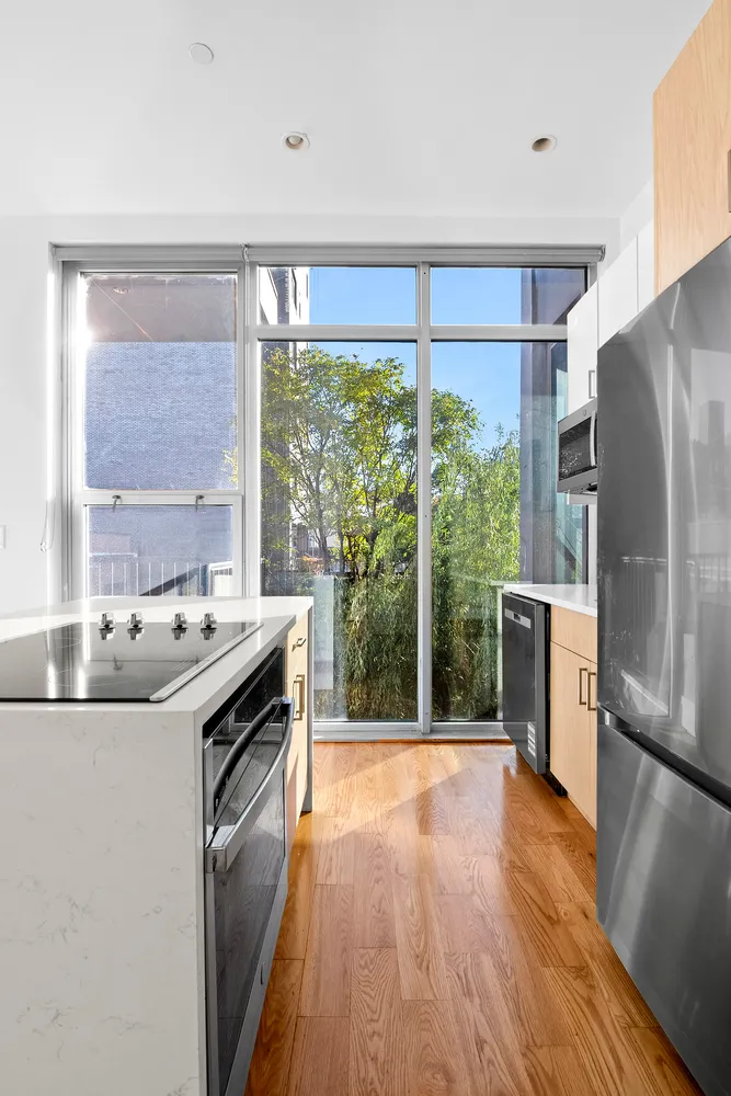 a kitchen with a stove a sink and a refrigerator