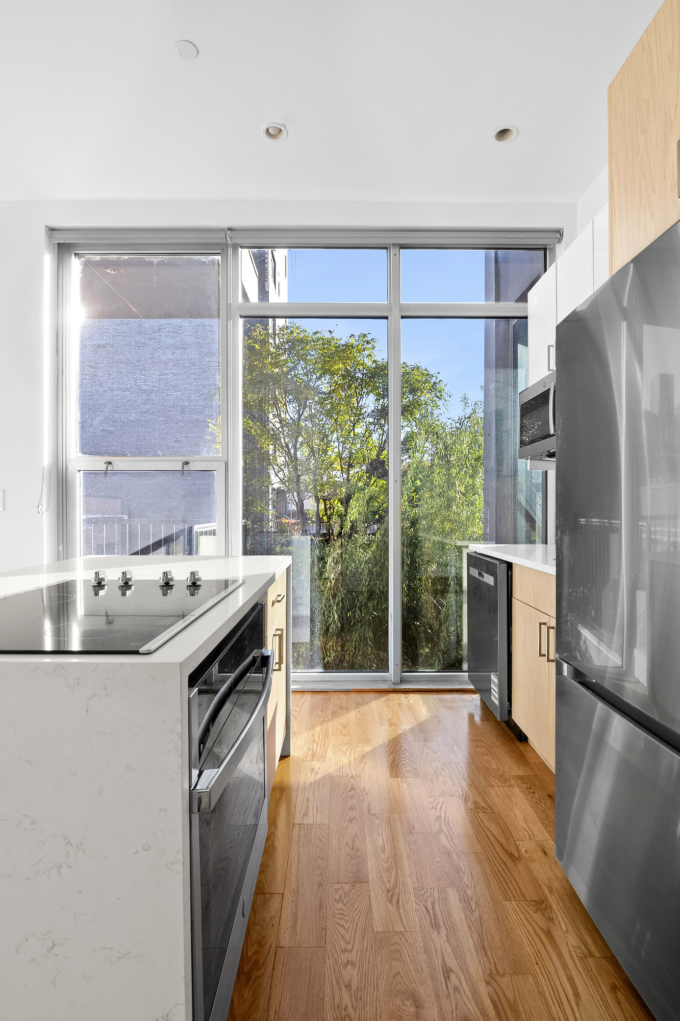 480 Humboldt Street, Unit 3B Brooklyn, NY 11211 - Photo 13 of 19 a kitchen with a stove a sink and a refrigerator