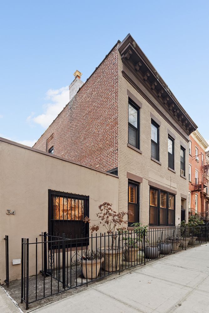 a front view of a house with iron fence