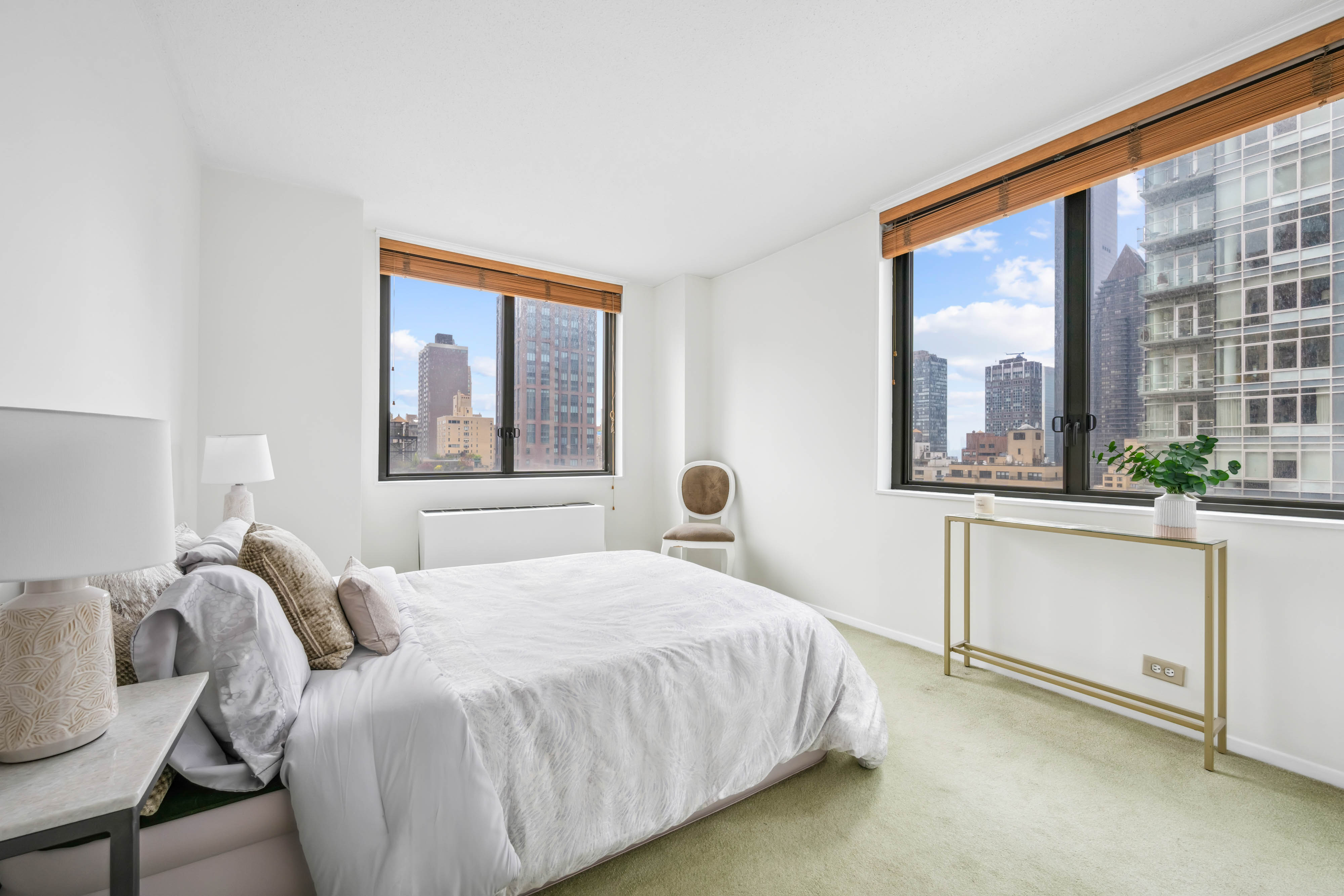 300 East 54th Street, Unit 15C Manhattan, NY 10022 - Photo 3 of 10 a bedroom with a bed and a large window