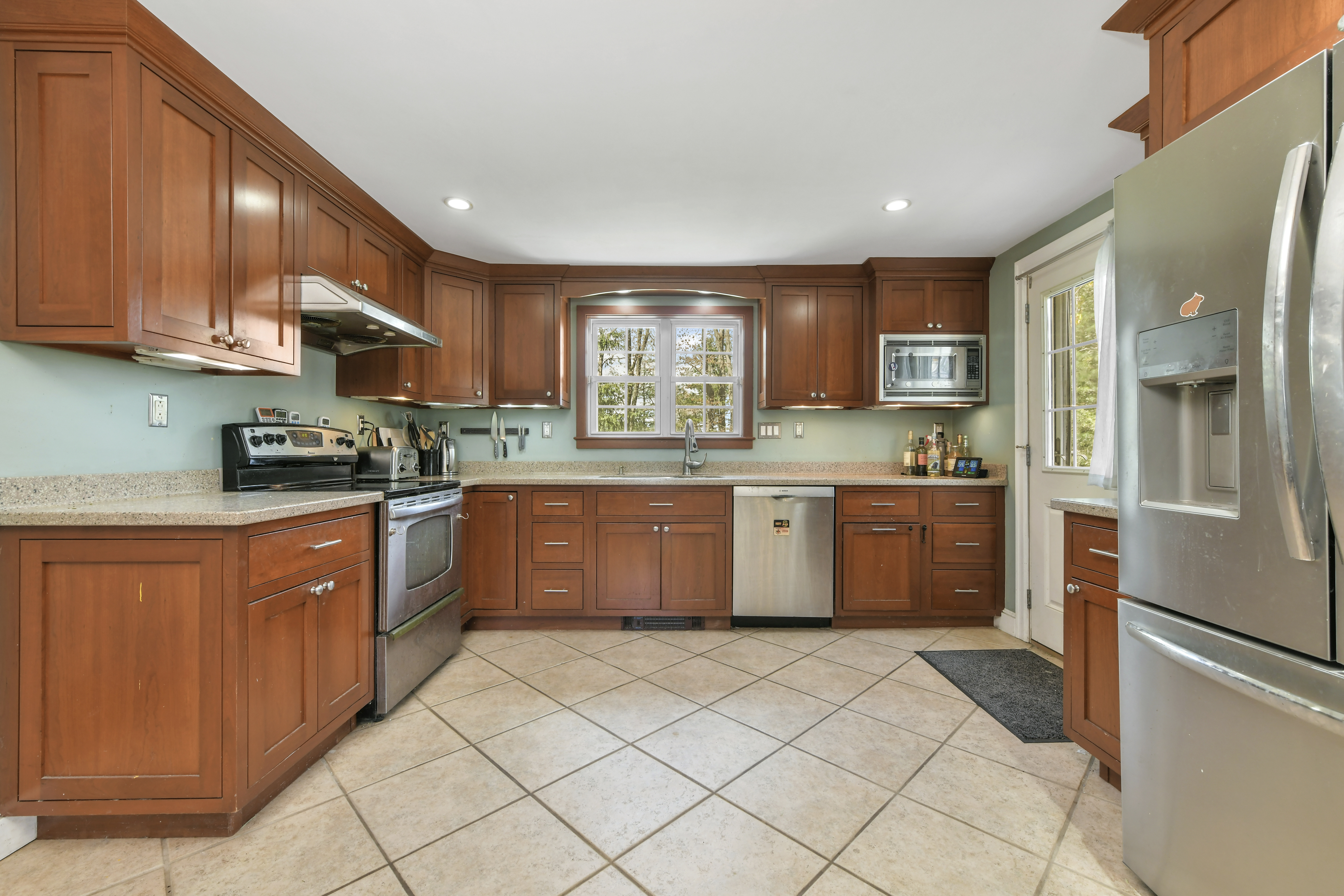 50 Rustic Road Walpole, MA 02032 - Photo 4 of 16 a kitchen with stainless steel appliances granite countertop a stove sink and cabinets