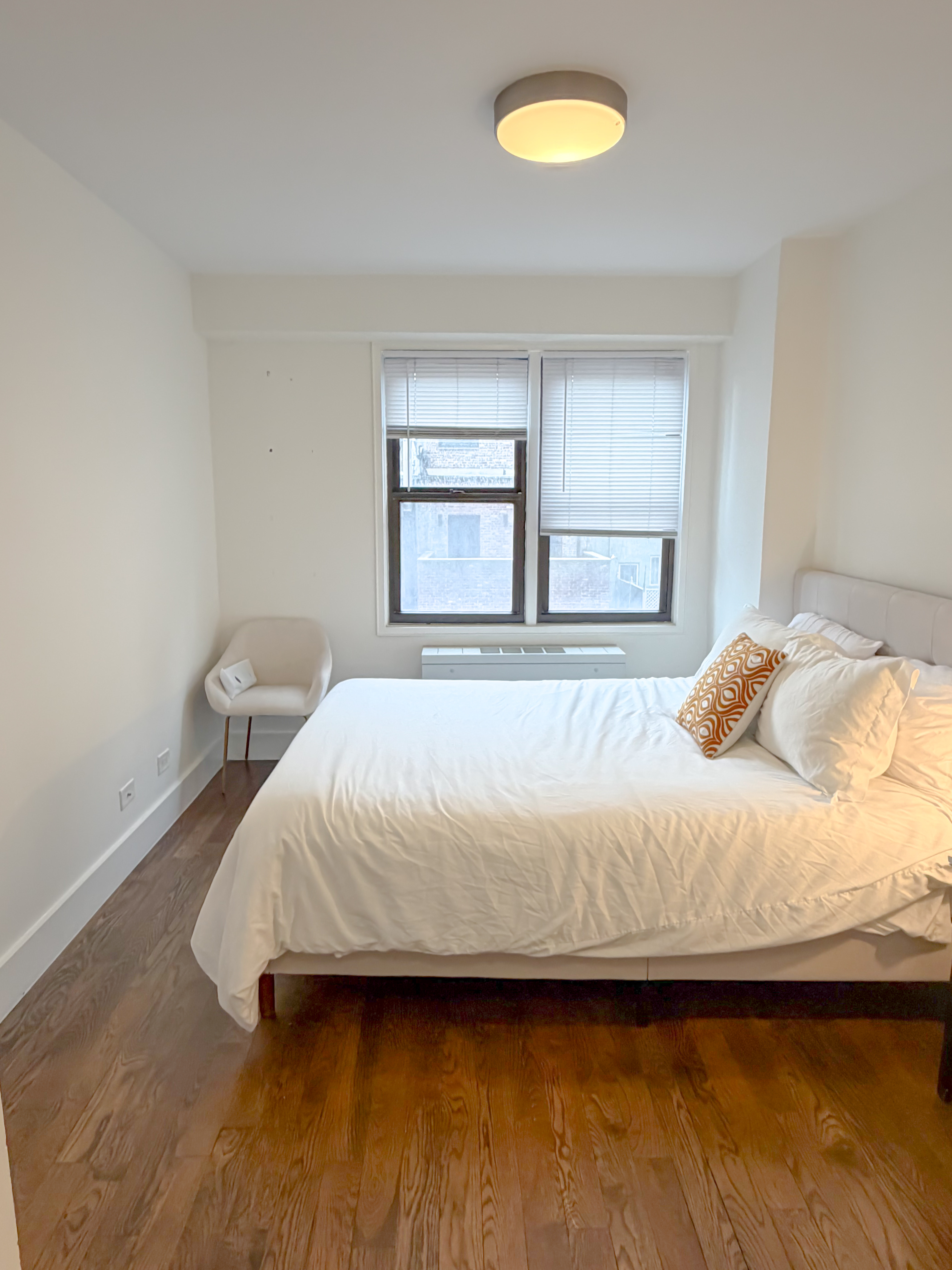 220 East 63rd Street, Unit 4N Manhattan, NY 10065 - Photo 5 of 13 a bedroom with a bed and a window