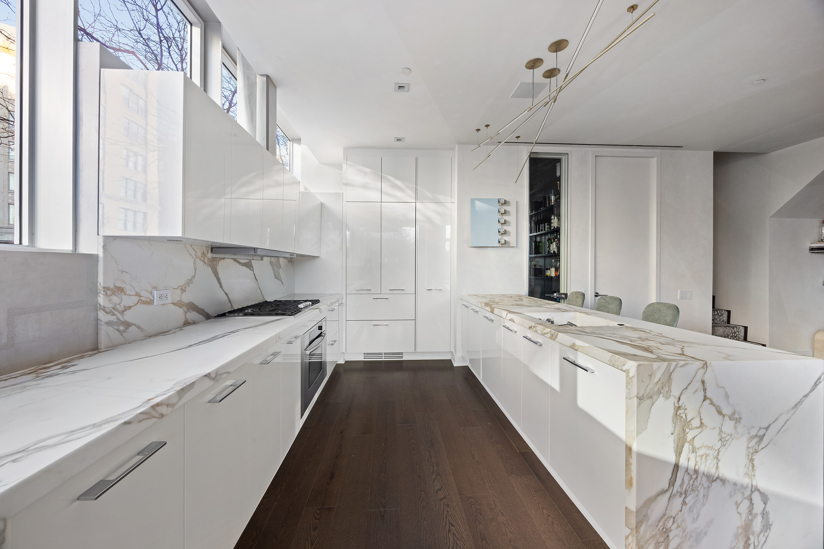 471 Washington Street, Unit 1B Manhattan, NY 10013 - Photo 8 of 16 a large white kitchen with stainless steel appliances granite countertop a lot of counter space and a refrigerator
